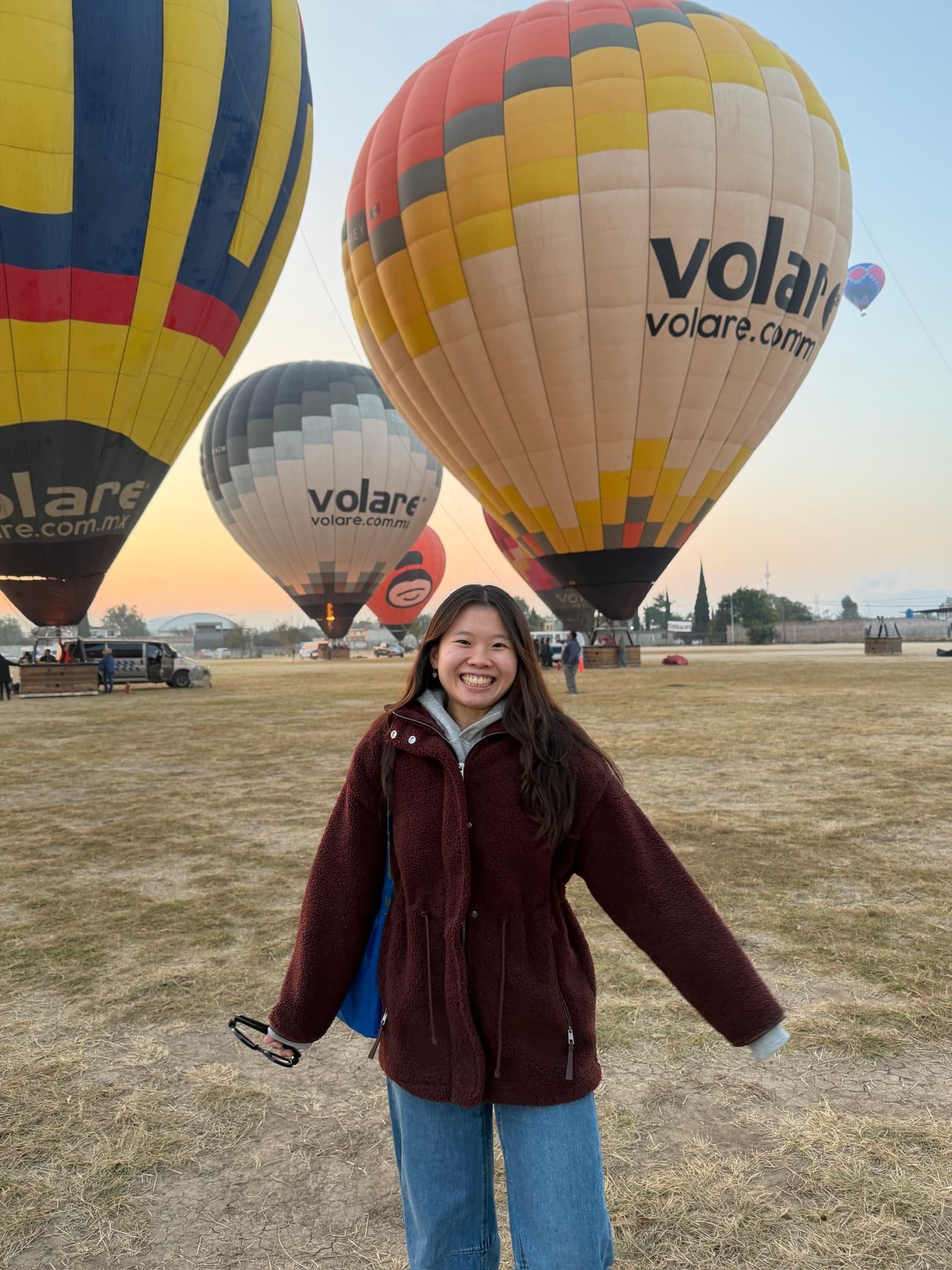 Erica standing in front of hot air balloons